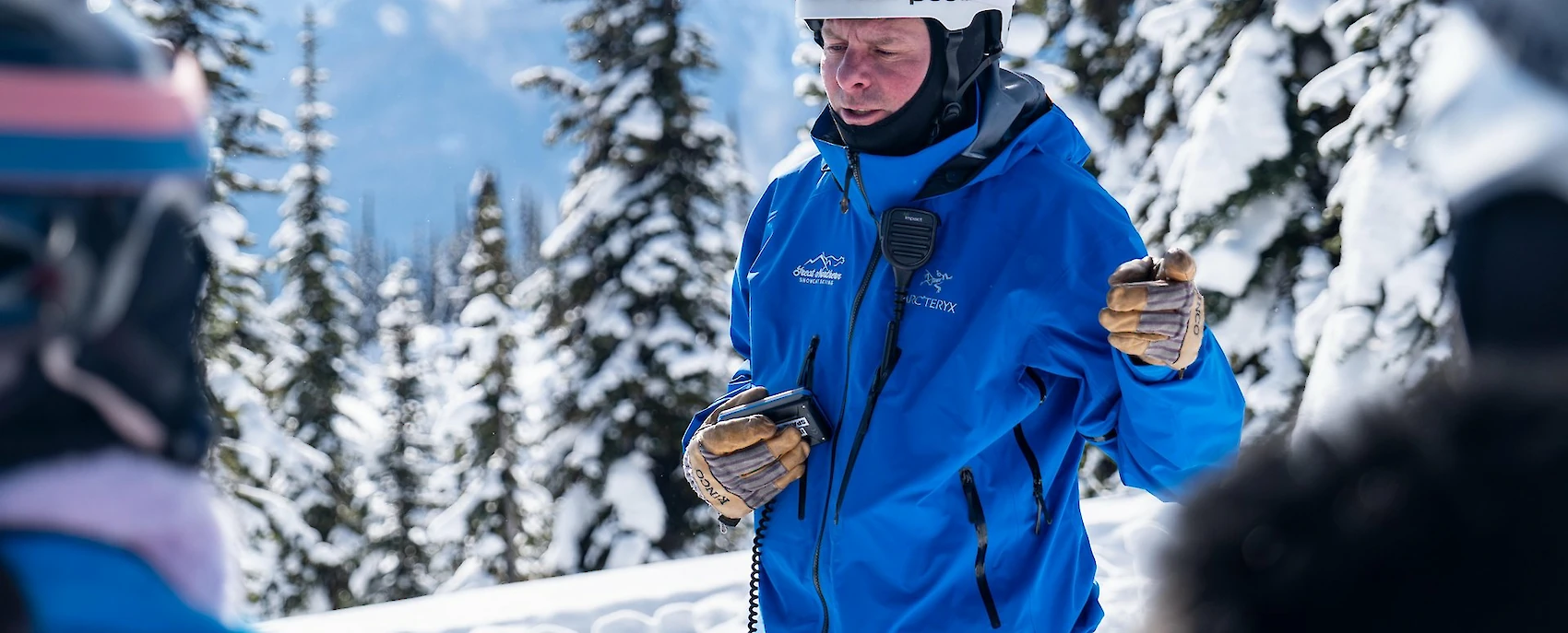 Ski instructor in training during certification course at Revelstoke, with snowy mountain backdrop